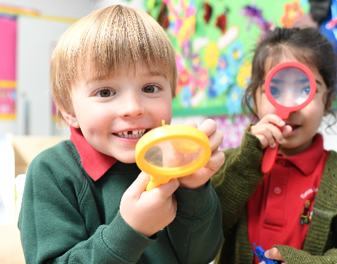pupils holding magnifying glasses