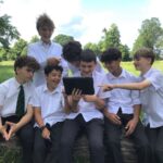 boys watching something on a tablet