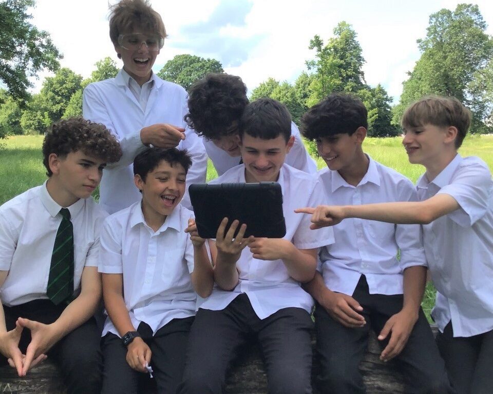 boys watching something on a tablet