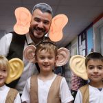 students wearing big ear props