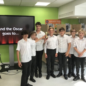 boys holding a trophy